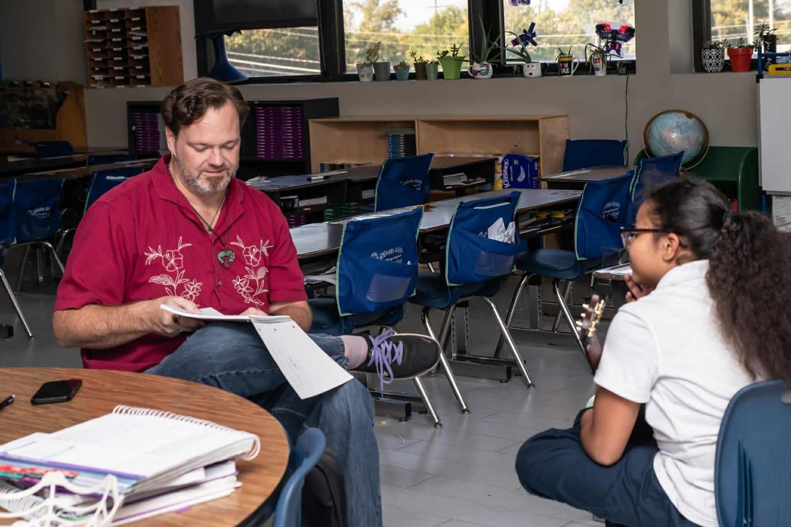 John Ford reads through sheet music with a student during a lesson